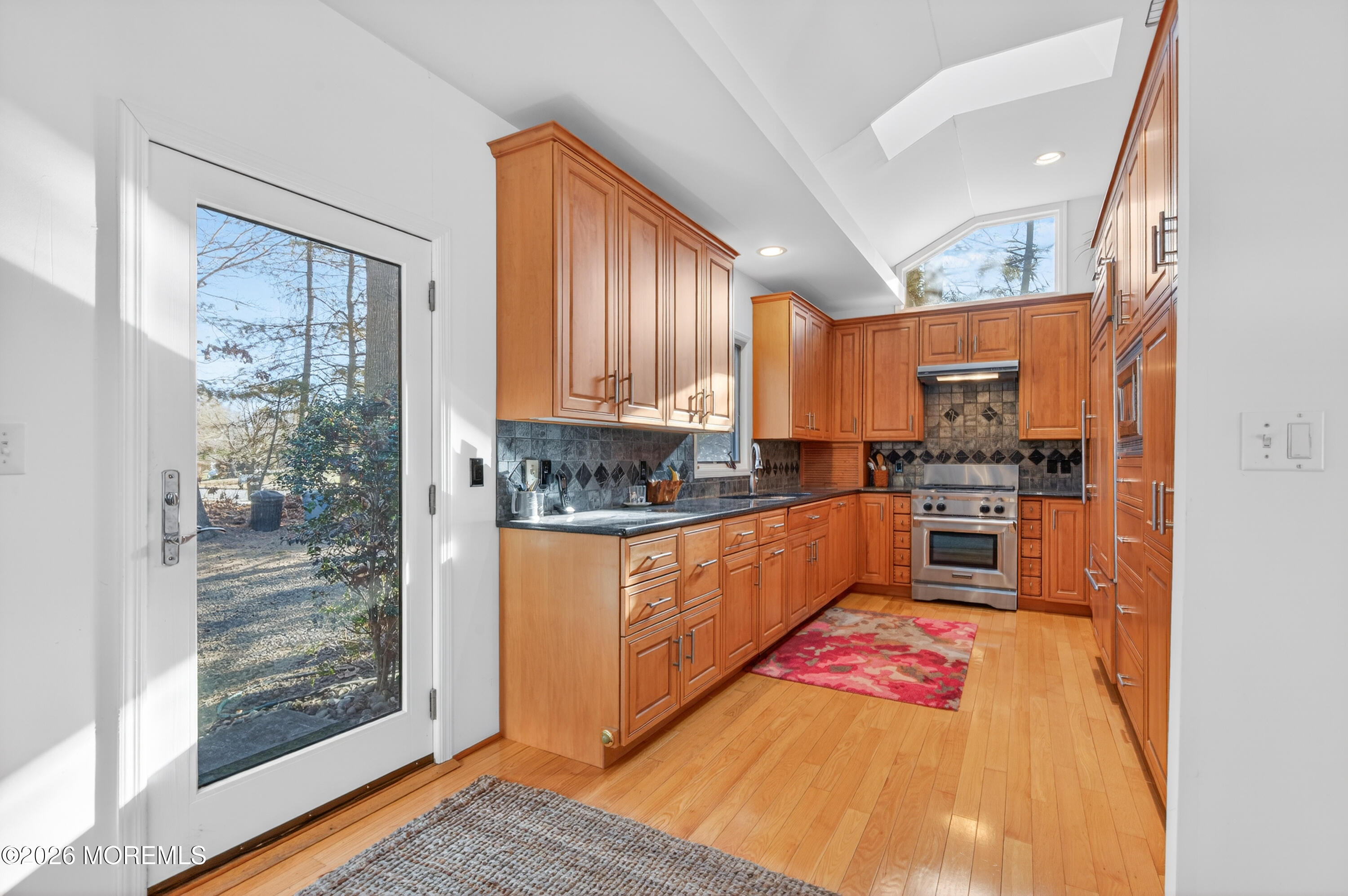 184 Smithburg Road Manalapan, NJ 07726 - Photo 6 of 45 a kitchen with stainless steel appliances granite countertop a refrigerator a stove and a sink with wooden floor