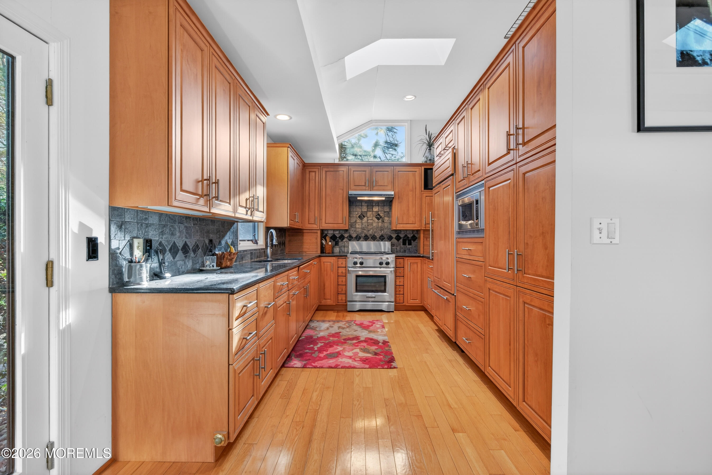 184 Smithburg Road Manalapan, NJ 07726 - Photo 8 of 45 a large kitchen with stainless steel appliances granite countertop a stove and a wooden cabinets