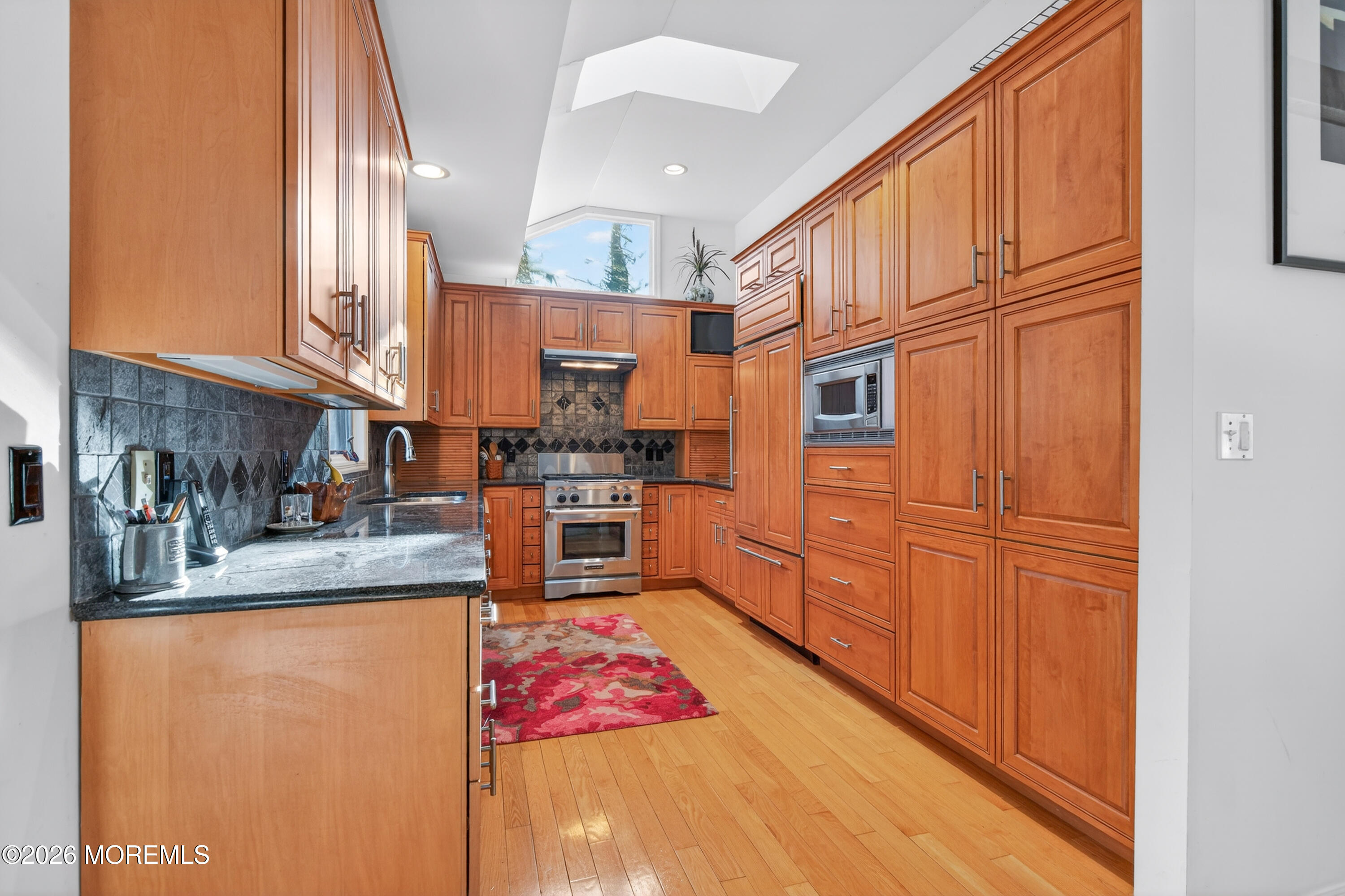 184 Smithburg Road Manalapan, NJ 07726 - Photo 9 of 45 a kitchen with stainless steel appliances granite countertop a refrigerator sink stove and white cabinets