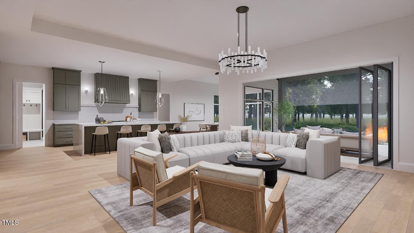 962 Shelley Road Raleigh, NC 27609 - Photo 11 of 34 a living room with furniture a chandelier and a view of kitchen