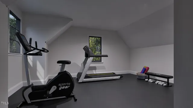 a room with gym equipment and wooden floor