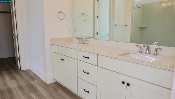 a bathroom with a double vanity sink and mirror