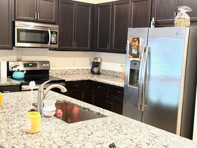 a kitchen with a sink and a stove top oven