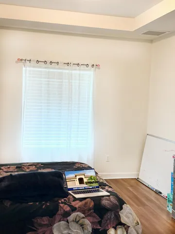 a bedroom with a bed and a window