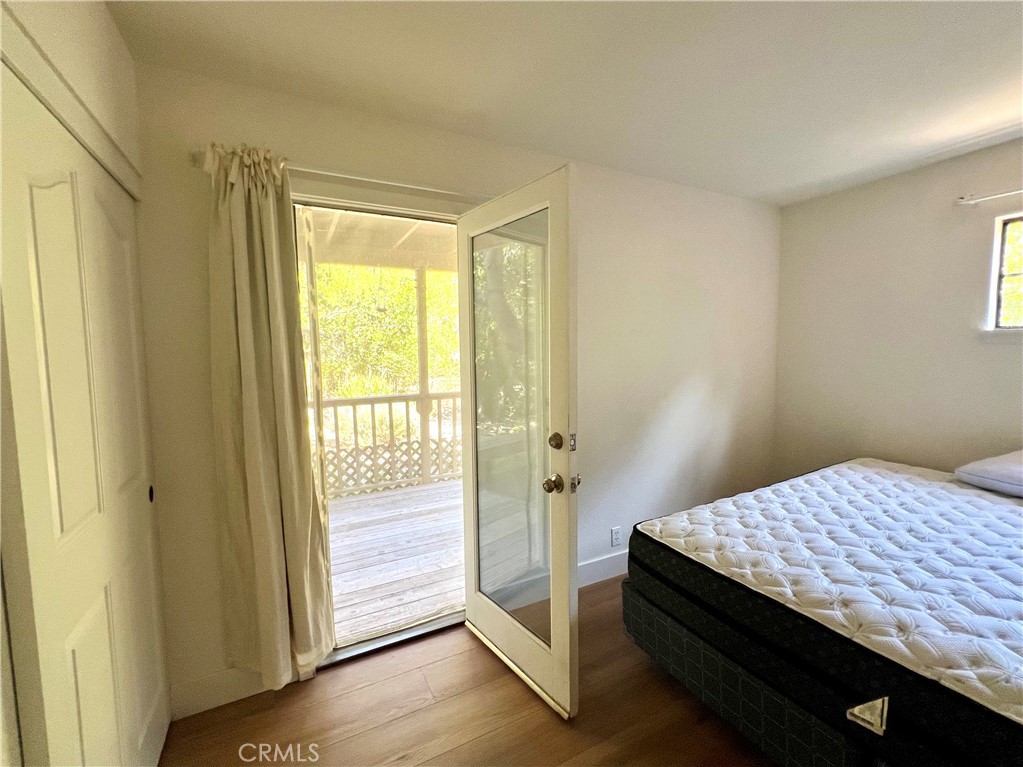 1530 Emerson Road Cambria, CA 93428 - Photo 21 of 54 Bedroom downstairs, with door leading out to back deck and yard.