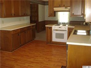 1305 Old Pageland Monroe Road Wingate, NC 28174 - Photo 4 of 5 a kitchen with a stove top oven sink and cabinets