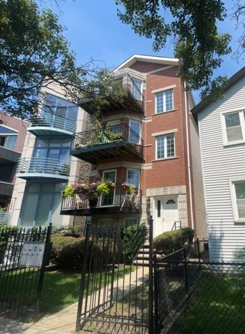 a front view of house and yard with green space