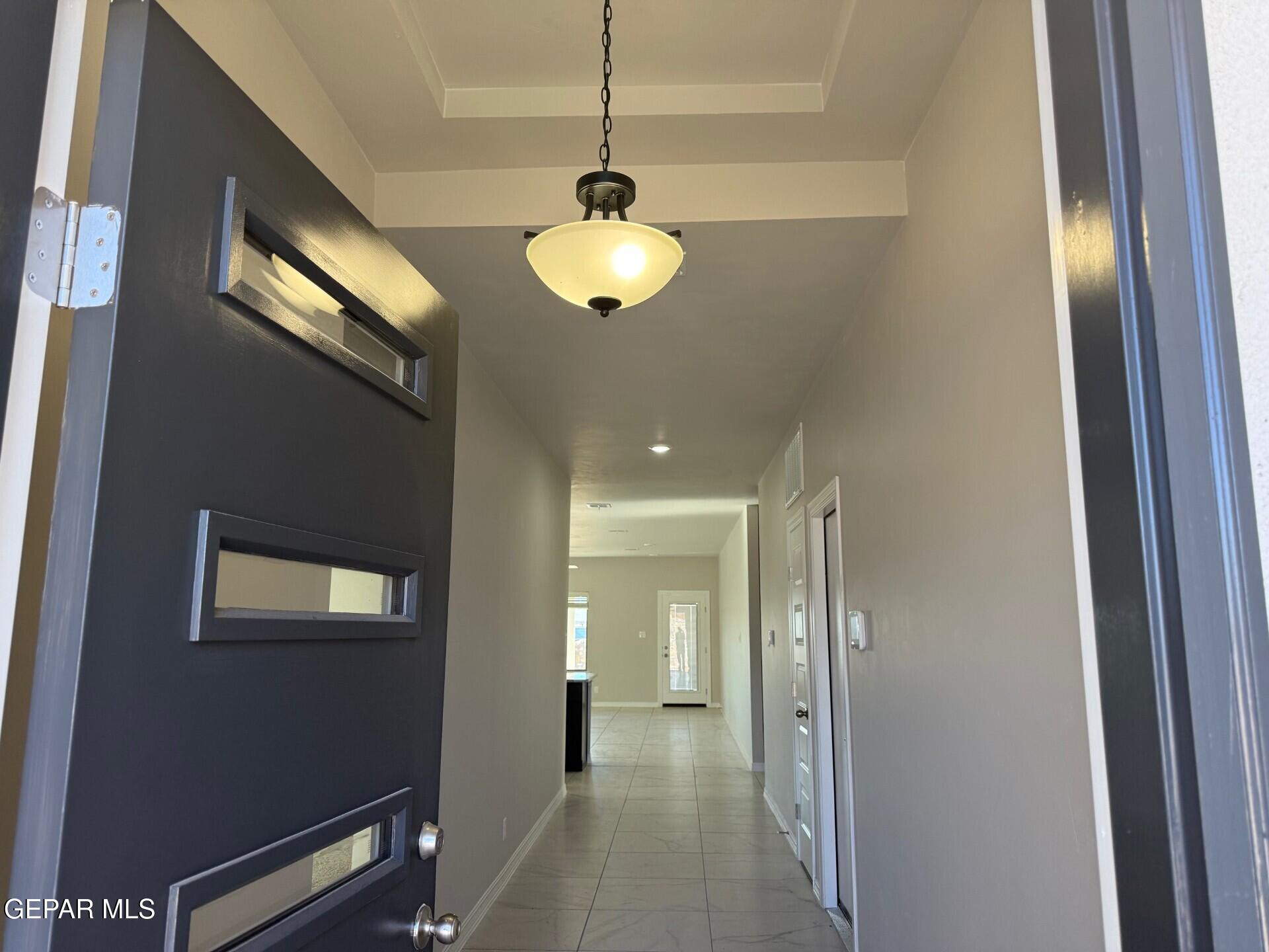 7703 California Stage Street Vinton, TX 79821 - Photo 2 of 14 a view of a hallway with wooden floor