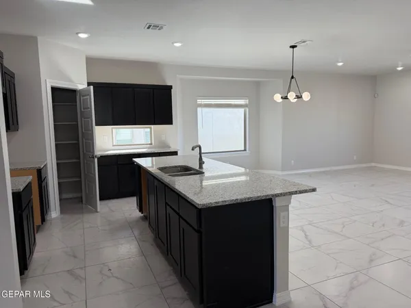 an open kitchen with a sink and an oven