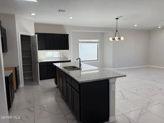an open kitchen with a sink and an oven