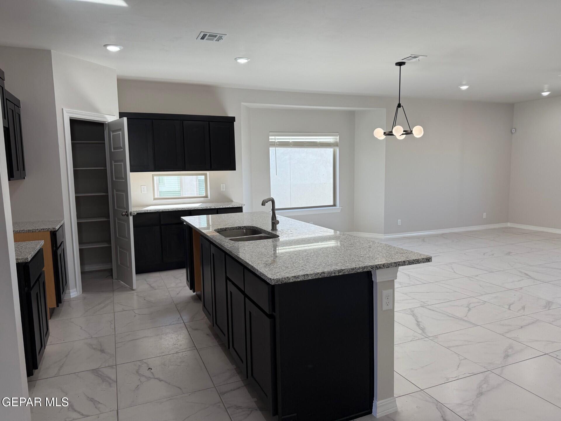 7703 California Stage Street Vinton, TX 79821 - Photo 7 of 14 a kitchen with stainless steel appliances granite countertop a sink stove and refrigerator