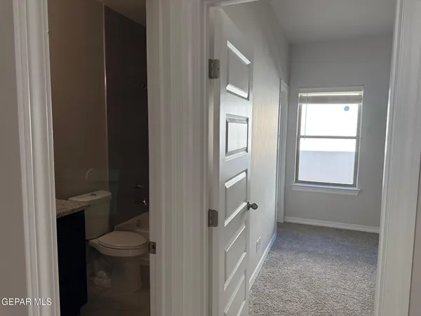 a bathroom with a granite countertop sink a large mirror and a shower