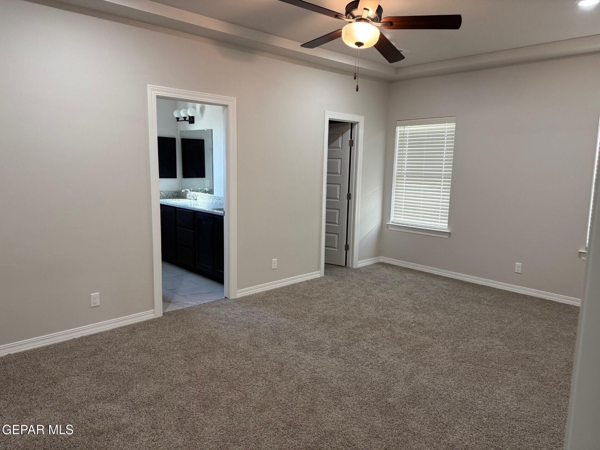 7703 California Stage Street Vinton, TX 79821 - Photo 10 of 14 a view of an empty room with a ceiling fan and window