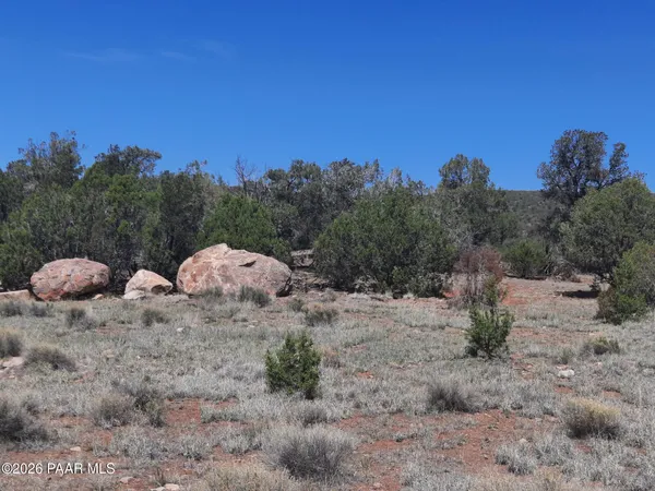a backyard of a house with a yard and outdoor seating