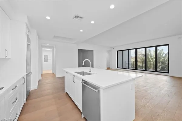 a open kitchen with stainless steel appliances granite countertop a sink and a counter