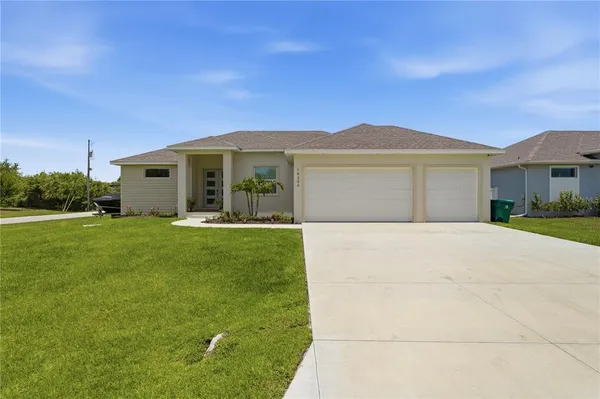 a front view of house with yard and green space