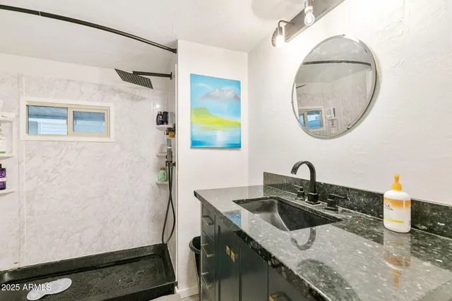 a bathroom with a sink and a mirror