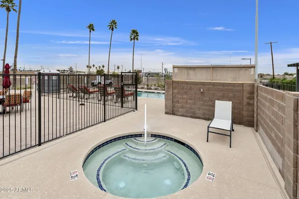 a view of a swimming pool with a lawn chairs