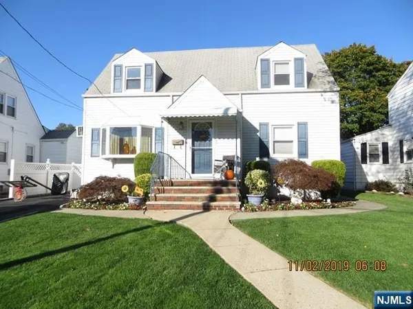 a front view of a house with a garden and plants