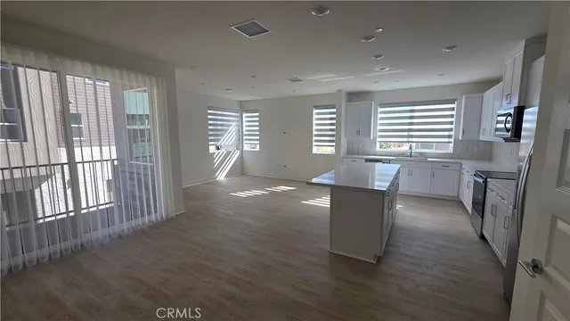 a kitchen with cabinets appliances and a counter space