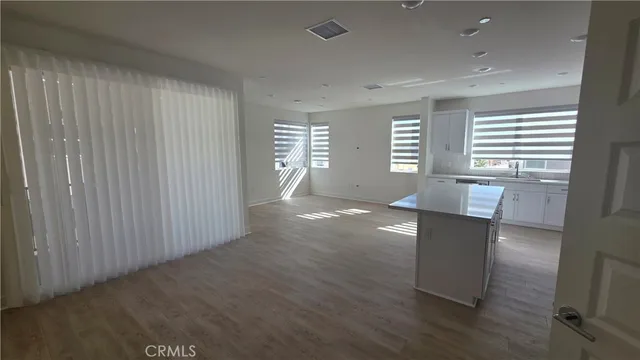 a kitchen with granite countertop cabinets appliances a sink and a window
