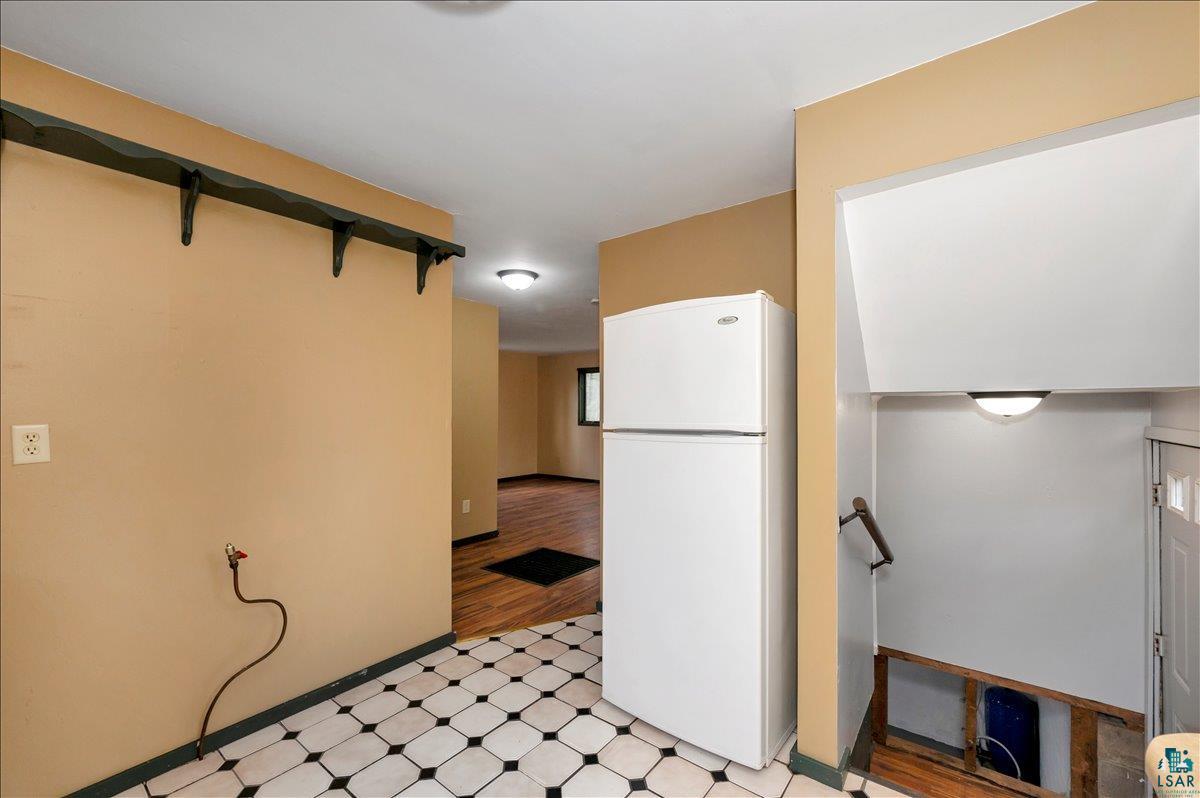 6355 Stoney Brook Road Alborn, MN 55702 - Photo 5 of 18 Kitchen with freestanding refrigerator and light floors