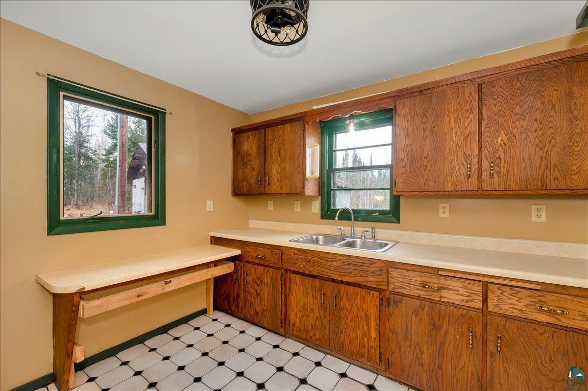 6355 Stoney Brook Road Alborn, MN 55702 - Photo 6 of 18 Kitchen featuring light flooring, wood finish cabinets, and light countertops