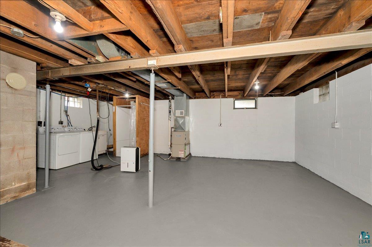 6355 Stoney Brook Road Alborn, MN 55702 - Photo 9 of 18 Below grade area with plenty of natural light, washer and dryer, and heating unit