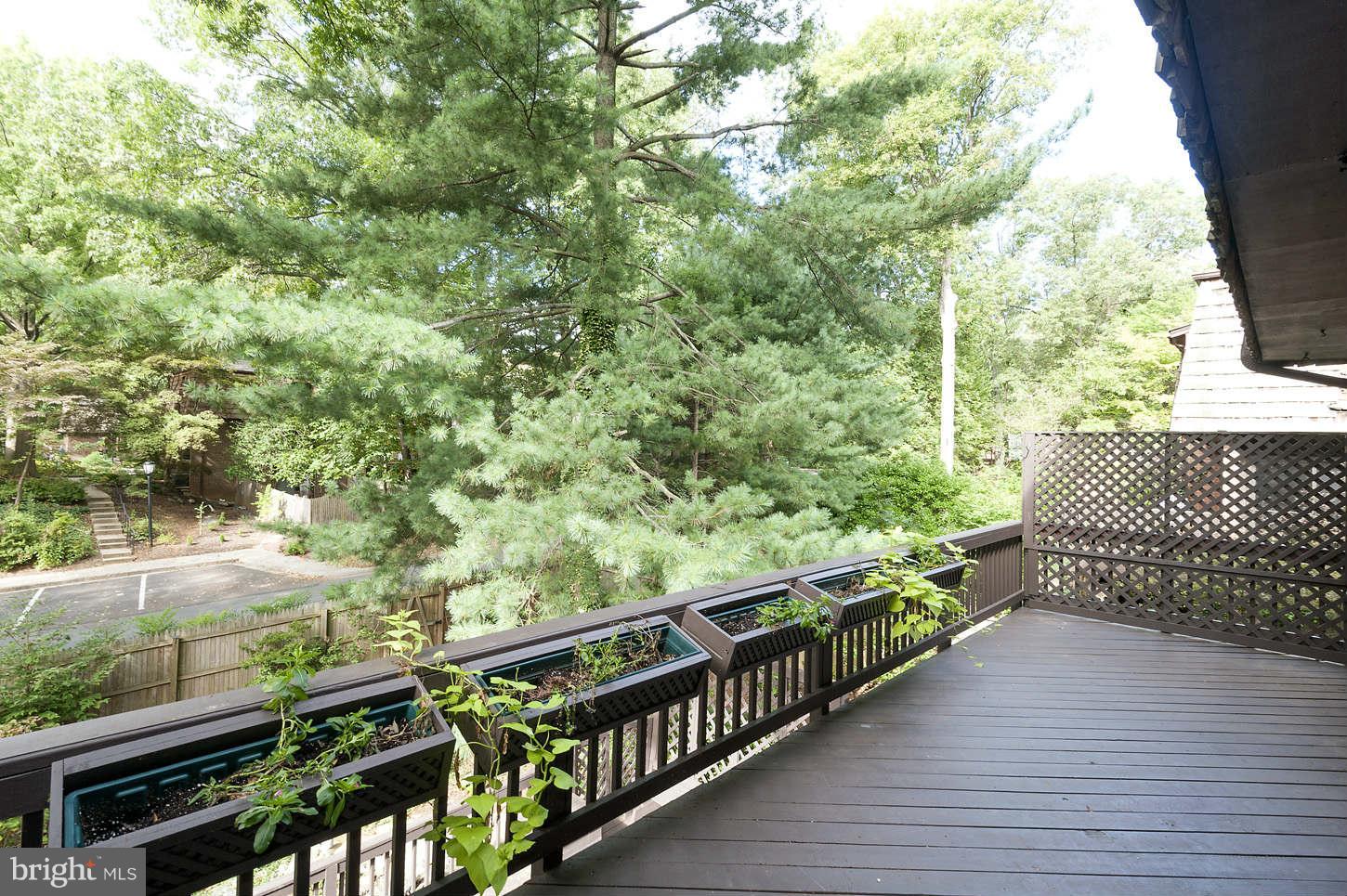 7964 Inverness Ridge Road Potomac, MD 20854 - Photo 13 of 28 a view of a balcony with wooden floor and fence