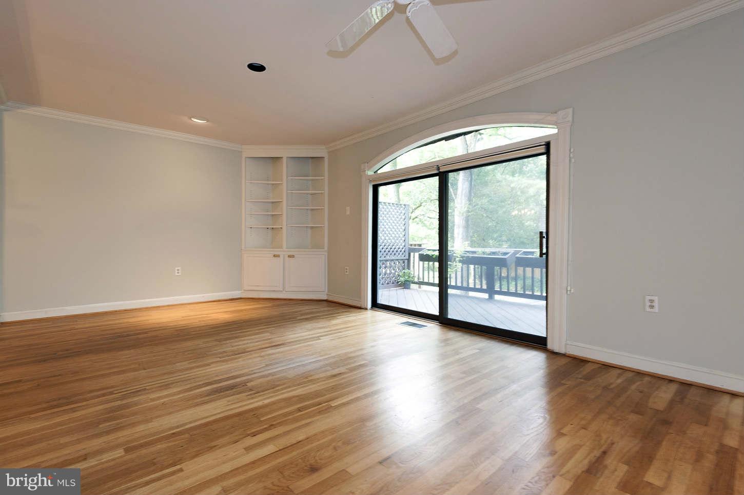 7964 Inverness Ridge Road Potomac, MD 20854 - Photo 18 of 28 a view of an empty room with wooden floor and a window