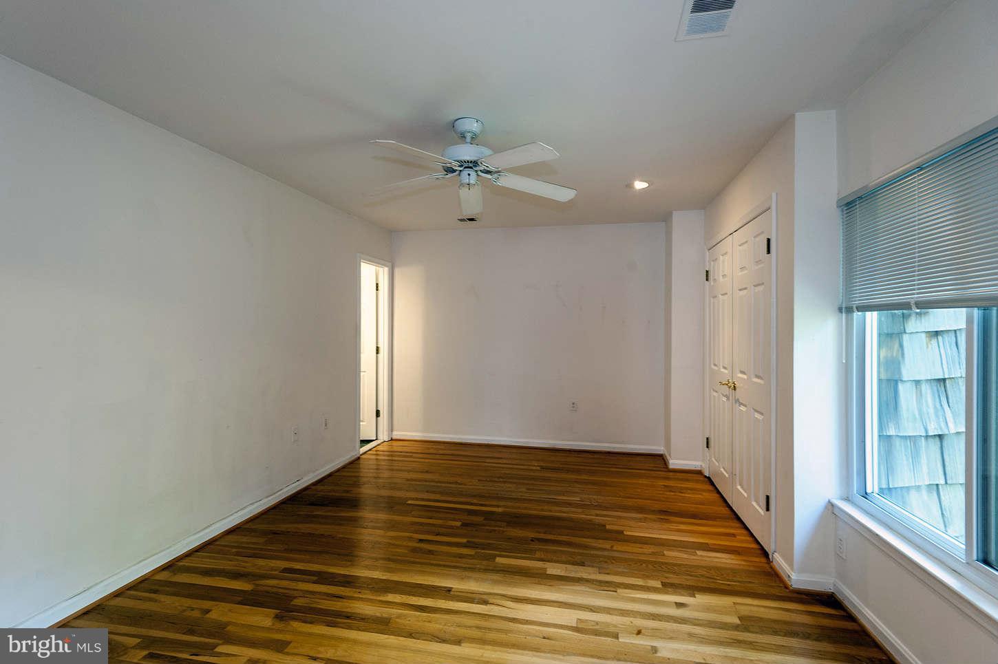 7964 Inverness Ridge Road Potomac, MD 20854 - Photo 20 of 28 a view of an empty room with window and chandelier fan
