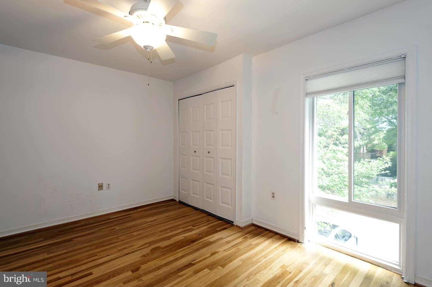 7964 Inverness Ridge Road Potomac, MD 20854 - Photo 21 of 28 a view of an empty room with wooden floor and a window