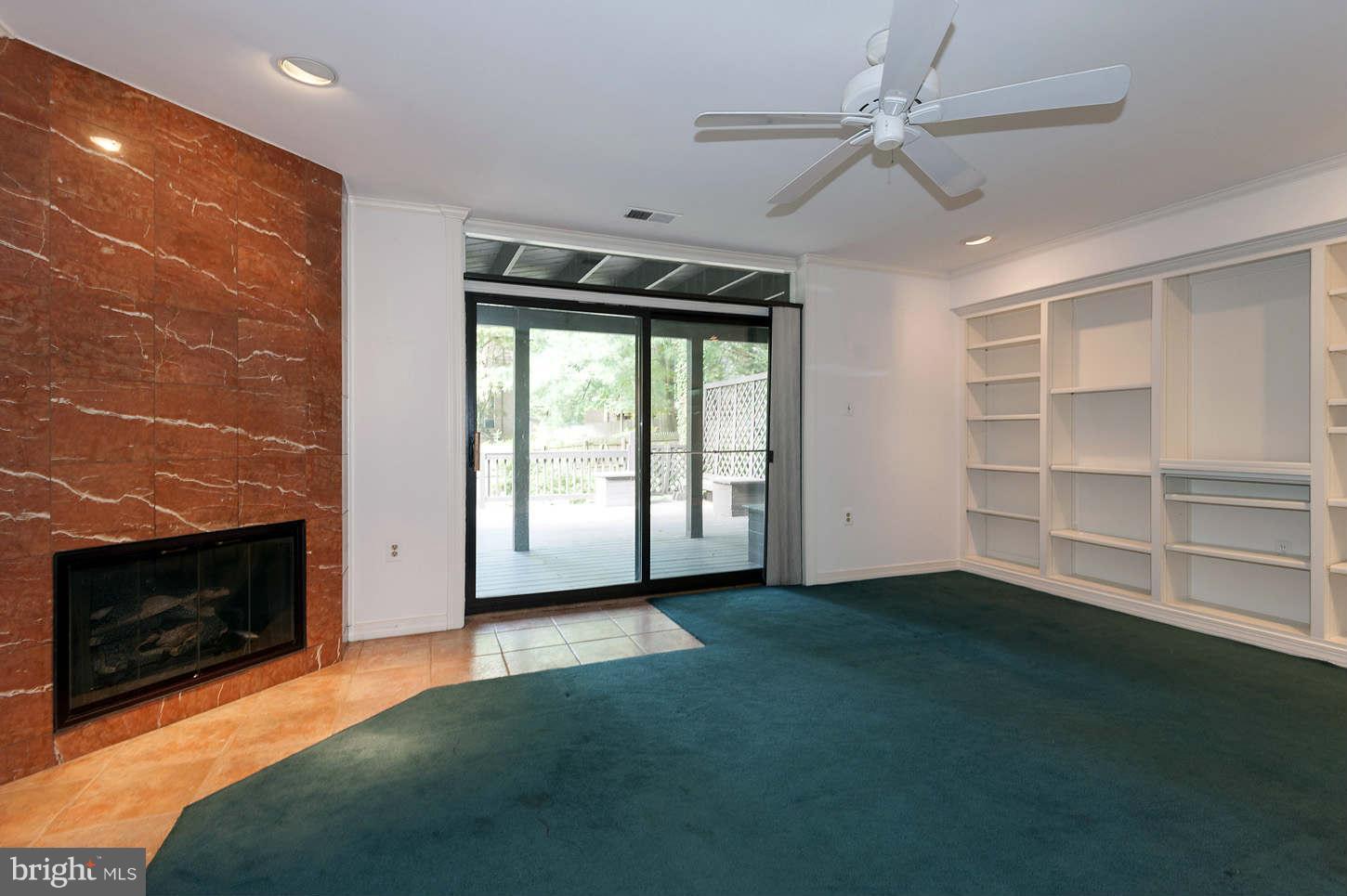 7964 Inverness Ridge Road Potomac, MD 20854 - Photo 25 of 28 a view of an empty room with a fireplace and a window