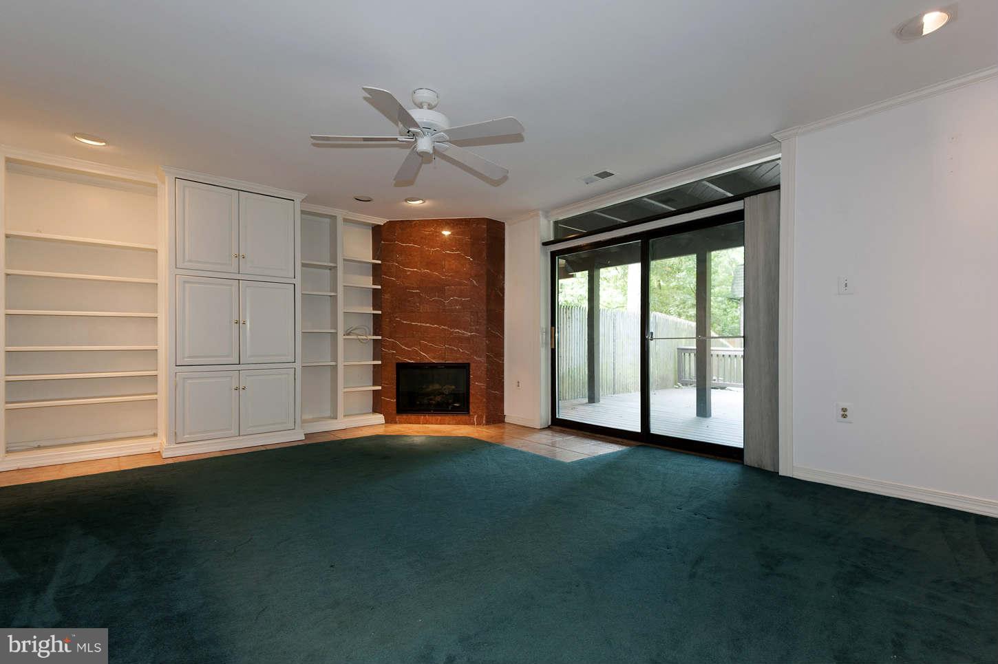 7964 Inverness Ridge Road Potomac, MD 20854 - Photo 26 of 28 a view of an empty room with a fireplace and a window