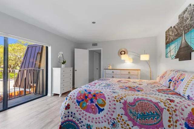 a bedroom with a bed and a painting on the wall