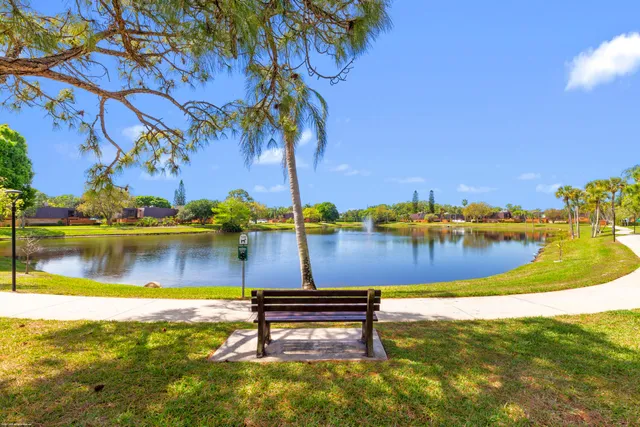 a view of a lake with a table and chairs