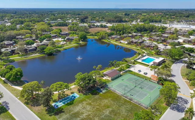 an aerial view of a houses with a lake view