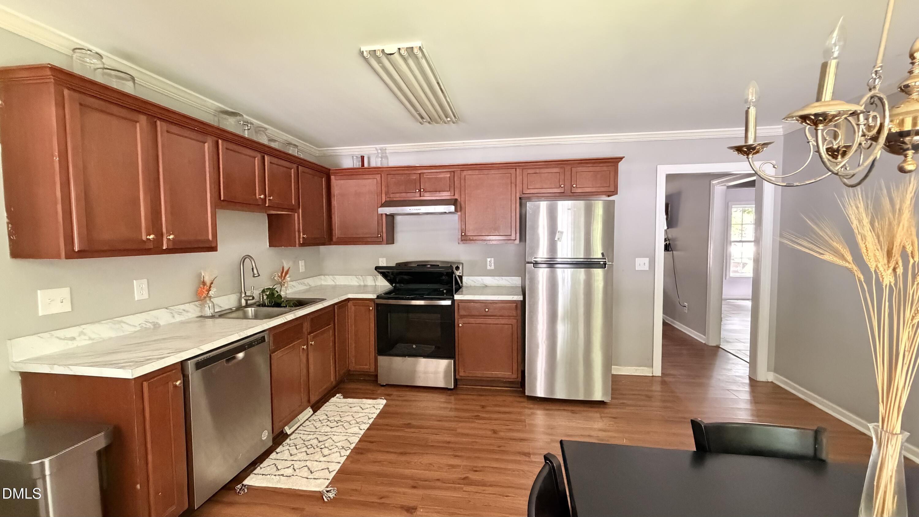 229 Sterling Way Angier, NC 27501 - Photo 9 of 10 a kitchen with stainless steel appliances granite countertop a refrigerator and a stove top oven