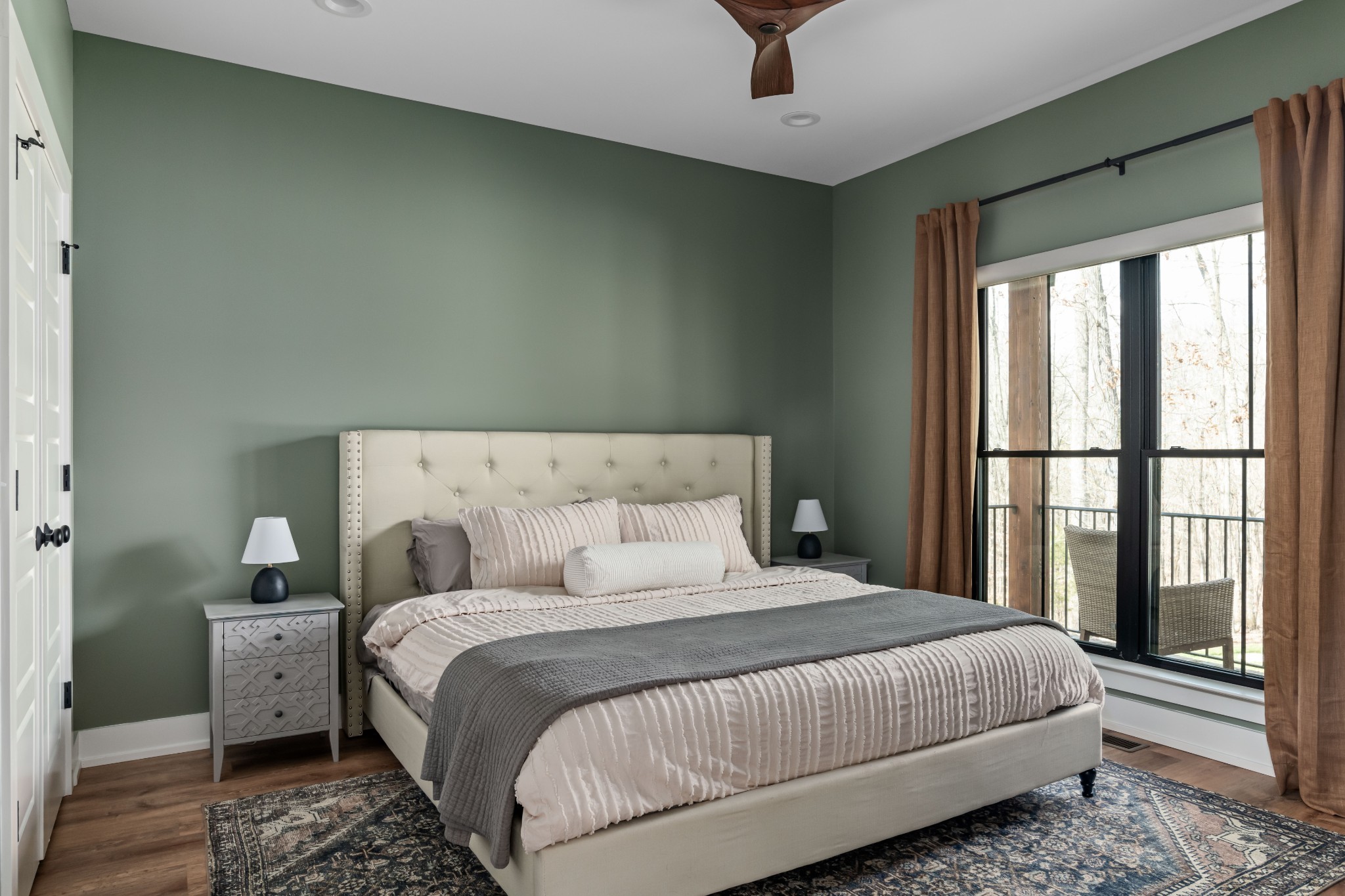 7361 Liberty Road Fairview, TN 37062 - Photo 32 of 71 a bedroom with a large bed and a chandelier