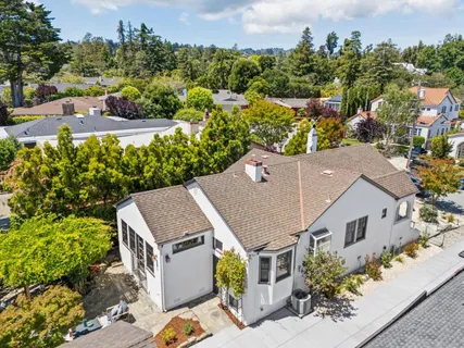 an aerial view of a house with a yard