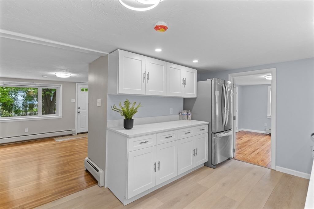 5 Phoenix Street Worcester, MA 01604 - Photo 13 of 32 a kitchen with stainless steel appliances a white counter top a window and a potted plant