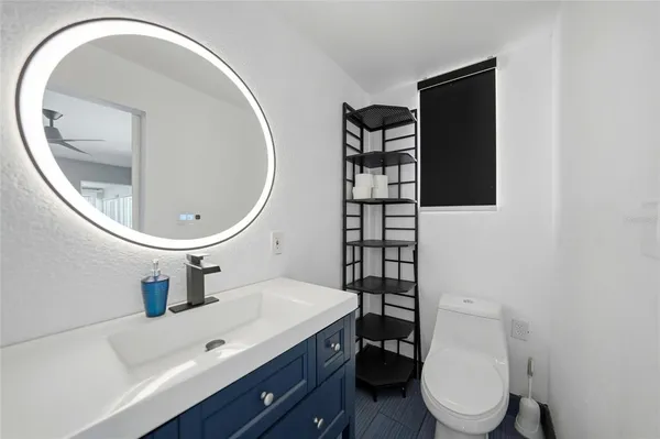 a bathroom with a sink a toilet and mirror