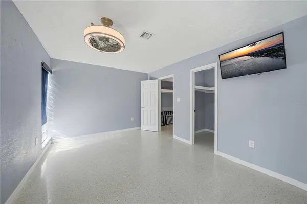 a bedroom with a large bed and a large window