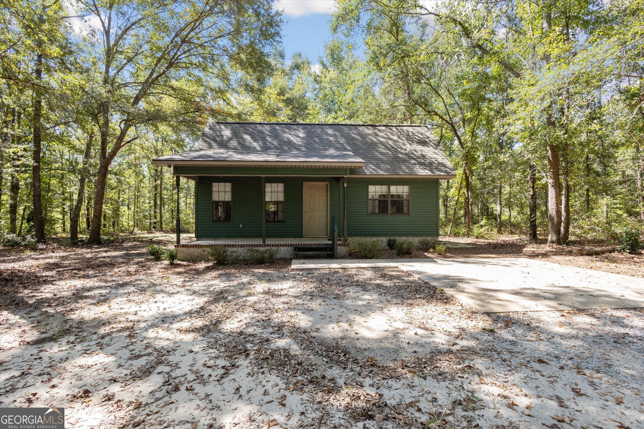 963 Johnny Brannen Road Statesboro, GA 30458 - Photo 1 of 1 a front view of a house with a garden