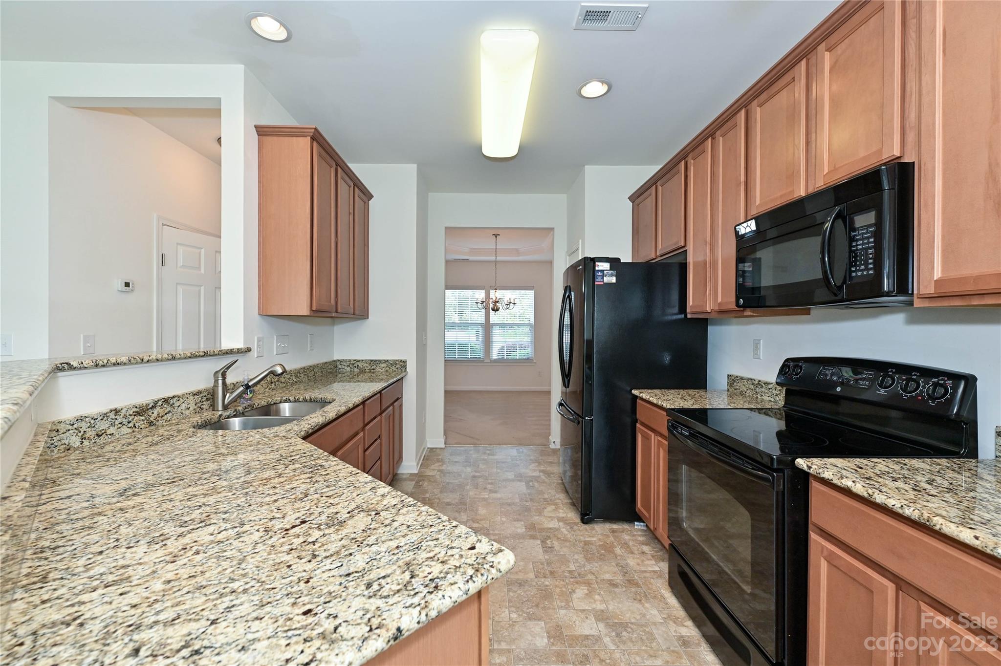 530 White Springs Road, Unit 21 Fort Mill, SC 29708 - Photo 14 of 42 a kitchen with stainless steel appliances granite countertop a stove refrigerator sink and microwave