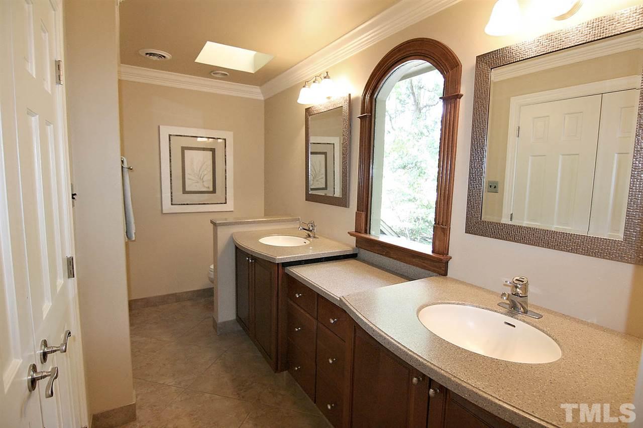 8005 Shellnut Road Raleigh, NC 27615 - Photo 17 of 25 Master Bath with Pizazz -- Recently Updated with Frameless Shower Door and Finely Detailed Cabinetry.