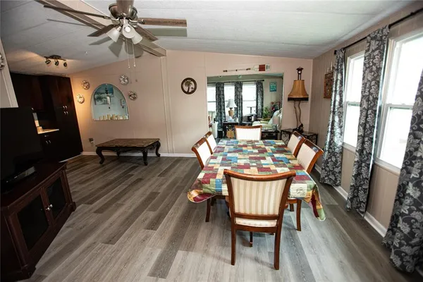a dining room with furniture window and wooden floor
