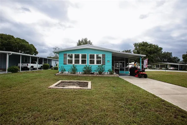 a view of house with outdoor space and swimming pool