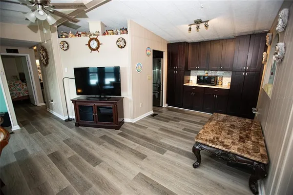 a bedroom with furniture a flat screen tv and refrigerator