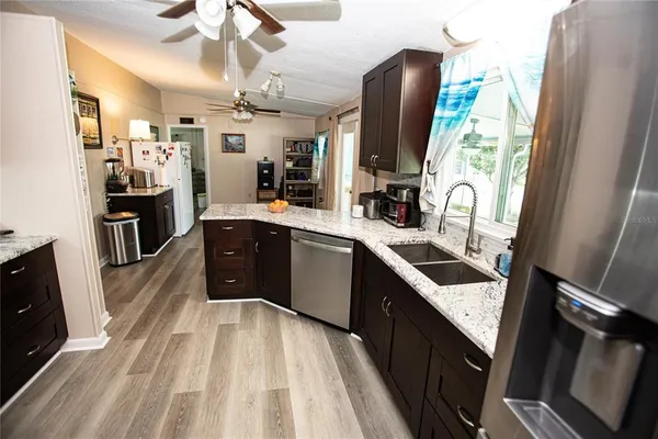 a kitchen with stainless steel appliances a sink stove and refrigerator